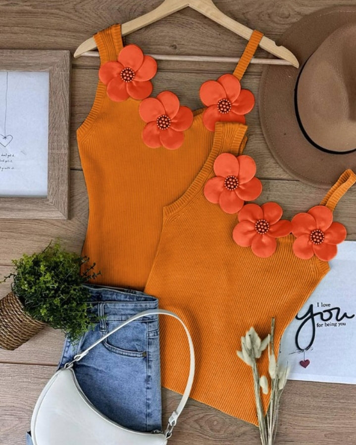 Premièrement : Ce 1 débardeur en tricot à motif floral et perles décoratives sans manches femme.