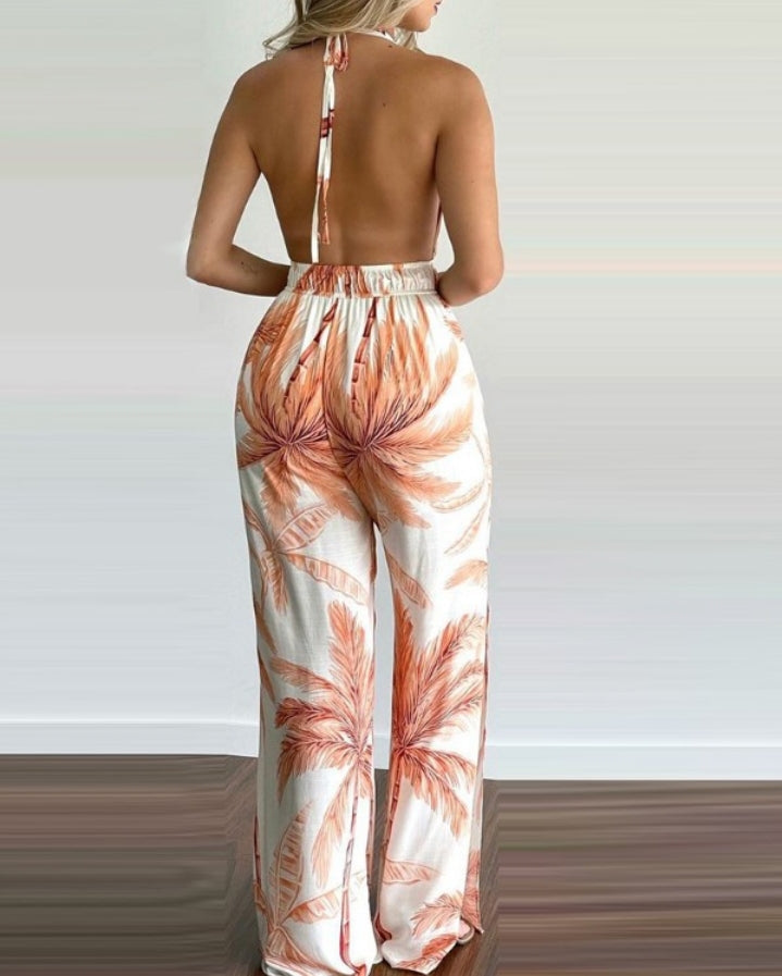 Premièrement : Plongez dans l’ambiance des îles avec cette Combinaison fente latérale dos nu imprimé tropical femme.