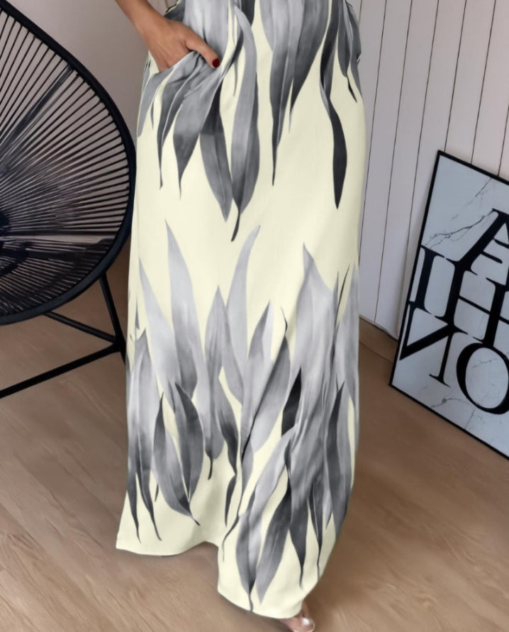 Premièrement : Cette robe longue décontractée à bretelles épaisses et imprimé végétal, coupe ajustée et fendue avec poches Femme.