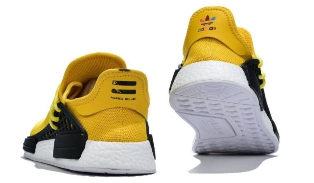les baskets Adidas Human Race NMD x Pharrell Yellow " Femme  sont un témoignage de l'engagement d'Adidas à combiner style et innovation.