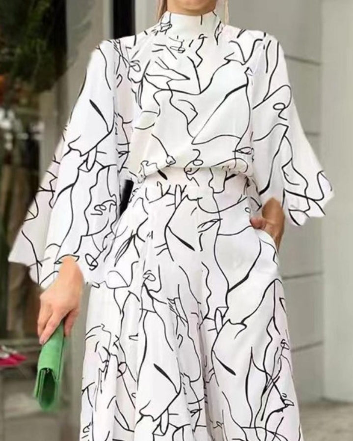 Premièrement : La Combinaison à jambe large et manches longues à imprimé abstrait femme est la pièce parfaite pour celles qui recherchent un style unique et sophistiqué.
