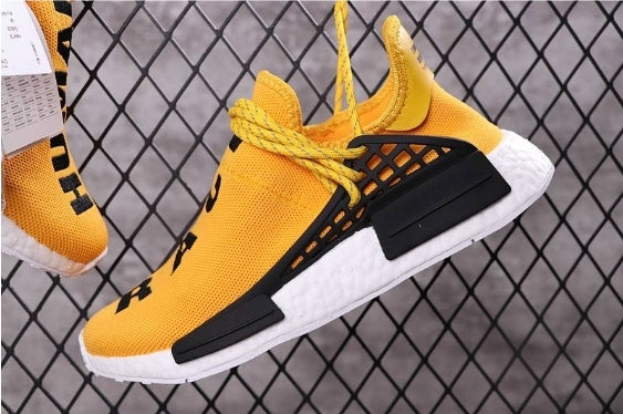 les baskets Adidas Human Race NMD x Pharrell Yellow " Femme  sont un témoignage de l'engagement d'Adidas à combiner style et innovation.