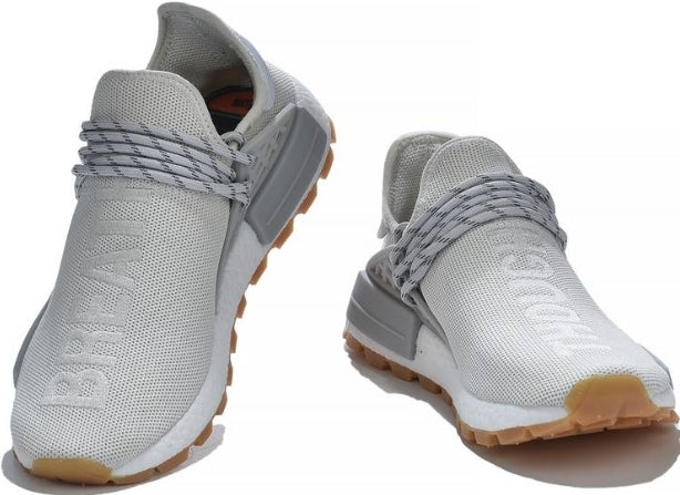 les baskets Adidas Human Race NMD x Pharrell Yellow " Femme  sont un témoignage de l'engagement d'Adidas à combiner style et innovation.
