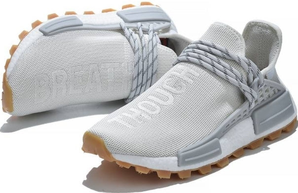les baskets Adidas Human Race NMD x Pharrell Yellow " Femme  sont un témoignage de l'engagement d'Adidas à combiner style et innovation.