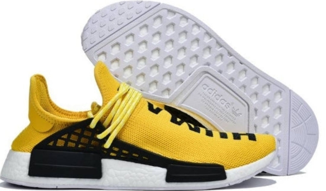 les baskets Adidas Human Race NMD x Pharrell Yellow " Femme  sont un témoignage de l'engagement d'Adidas à combiner style et innovation.