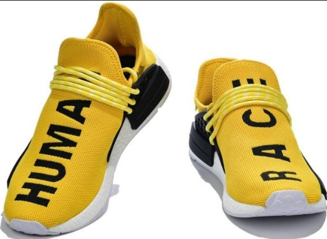 les baskets Adidas Human Race NMD x Pharrell Yellow " Femme  sont un témoignage de l'engagement d'Adidas à combiner style et innovation.