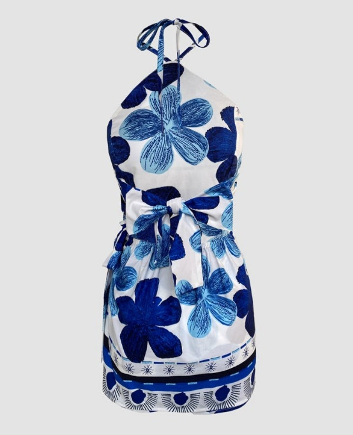 Premièrement : Laissez-vous séduire par cette combinaisonCombinaison une pièce à imprimé floral , col licou , ceinture nouée, avec jupe femme.
