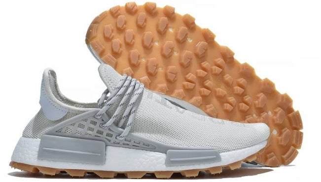 les baskets Adidas Human Race NMD x Pharrell Yellow " Femme  sont un témoignage de l'engagement d'Adidas à combiner style et innovation.