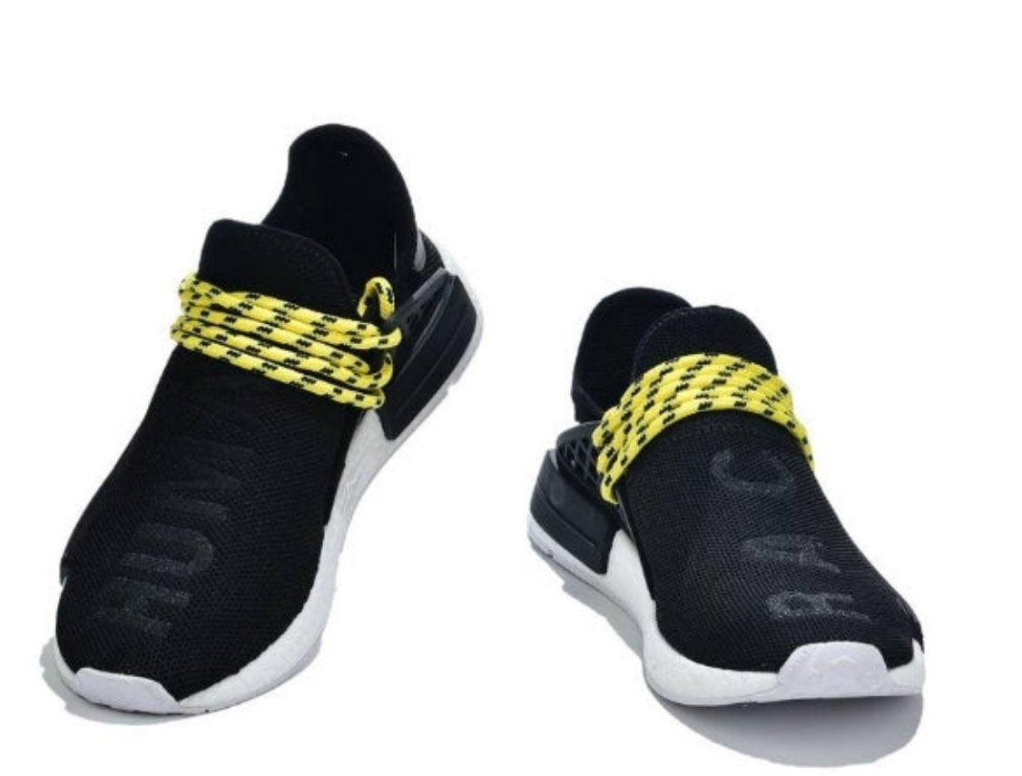 les baskets Adidas Human Race NMD x Pharrell Yellow " Femme  sont un témoignage de l'engagement d'Adidas à combiner style et innovation.